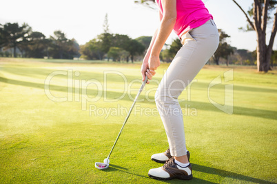 Close up of woman golfer preparing her shot