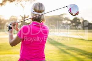Rear view of sportswoman playing golf