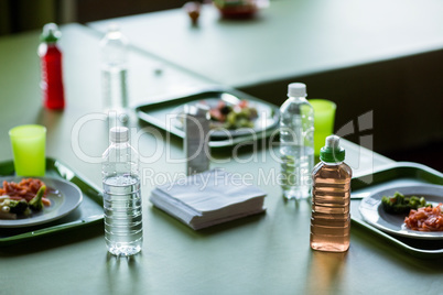Food with water bottles on table