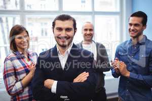 Coworkers clapping on businessman