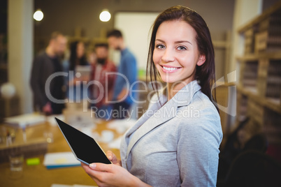 Young businesswoman holding digital tablet