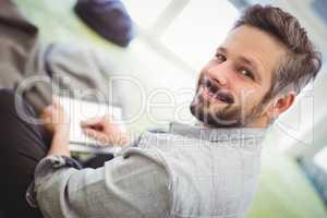 Businessman holding digital tablet in creative office