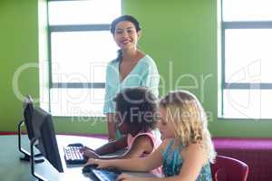 Teacher with children in computer class