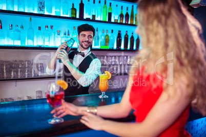 Bartender preparing cocktail for customer