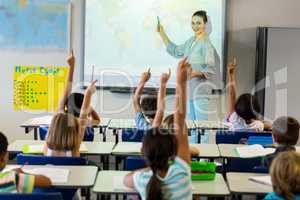 Teacher teaching schoolchildren using projector screen