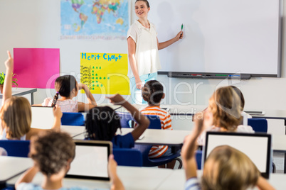 Teacher teaching students using whiteboard