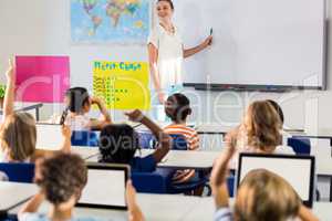 Teacher teaching students using whiteboard