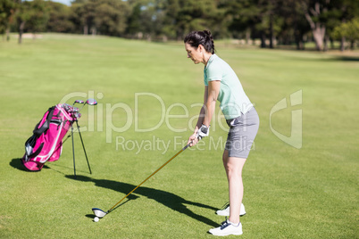 Side view of woman playing golf