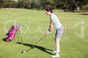 Side view of woman playing golf