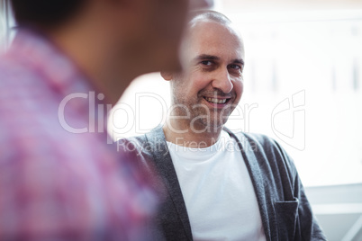 Businessman looking at coworker