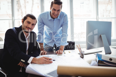 Portrait of smiling businessman with coworker