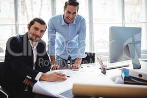 Portrait of smiling businessman with coworker