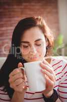 Woman smelling coffee