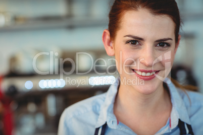 Portrait of happy barista at cafe