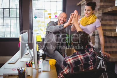 Happy coworkers high fiving