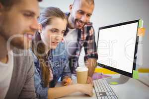 Businesswoman working with colleagues at desk in office