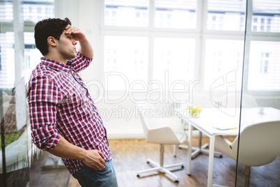 Upset businessman leaning on glass