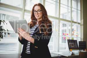 Businesswoman using digital tablet at creative office