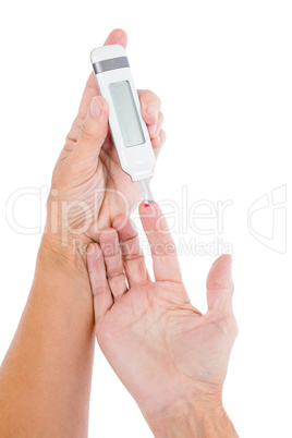 Cropped image of diabetic mature woman taking blood sample