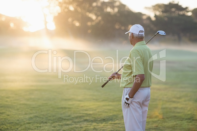 Mature golfer man standing on field