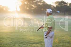 Mature golfer man standing on field