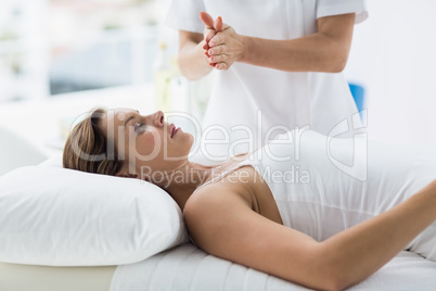 Woman receiving reiki treatment