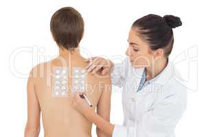 Doctor examining woman back