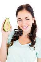 Portrait of cheerful woman holding avocado