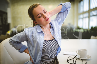 Tired businesswoman stretching