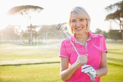 Woman posing with her golf club
