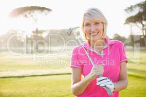 Woman posing with her golf club