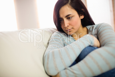 Sad woman sitting at home