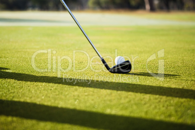 Close up of a golf ball and club