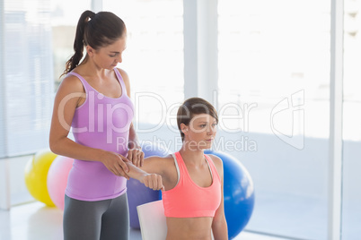 Trainer guiding woman