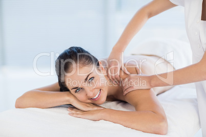 Portrait of smiling woman receiving massage