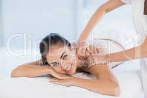 Portrait of smiling woman receiving massage