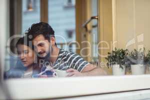 Young couple bonding at cafe