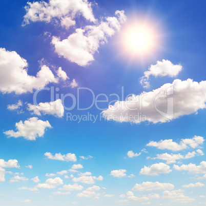 sun on blue sky with white clouds