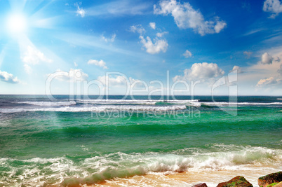 ocean, sandy beach and blue sky