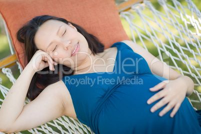 Young Pregnant Chinese Woman Resting in Hammock