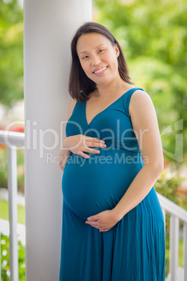 Portrait of Young Pregnant Chinese Woman on the Front Porch