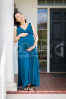 Portrait of Young Pregnant Chinese Woman on the Front Porch