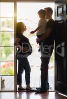 Pregnant Woman with Husband and Son Silhouetted in Doorway