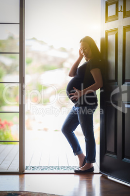 Chinese Pregnant Woman Silhouetted in Doorway