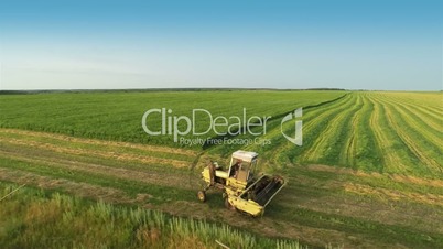 Harvesters Work on Green Field