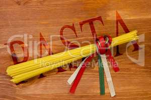 Pasta spaghetti tied with ribbons of the flag colors of Italy