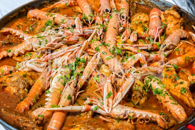 Paella with seafood and vegetables in a pan