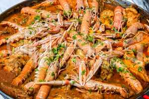 Paella with seafood and vegetables in a pan