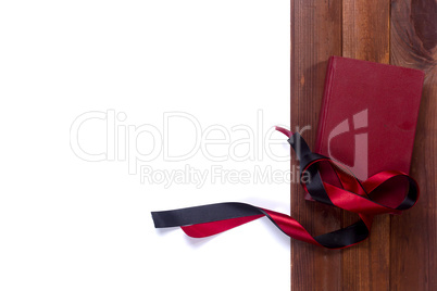 Black red satin ribbon and a book