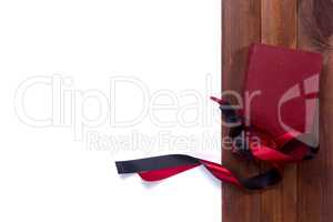 Black red satin ribbon and a book